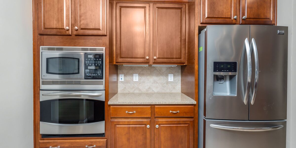 Elegant kitchen featuring stainless steel appliances and wooden cabinets.