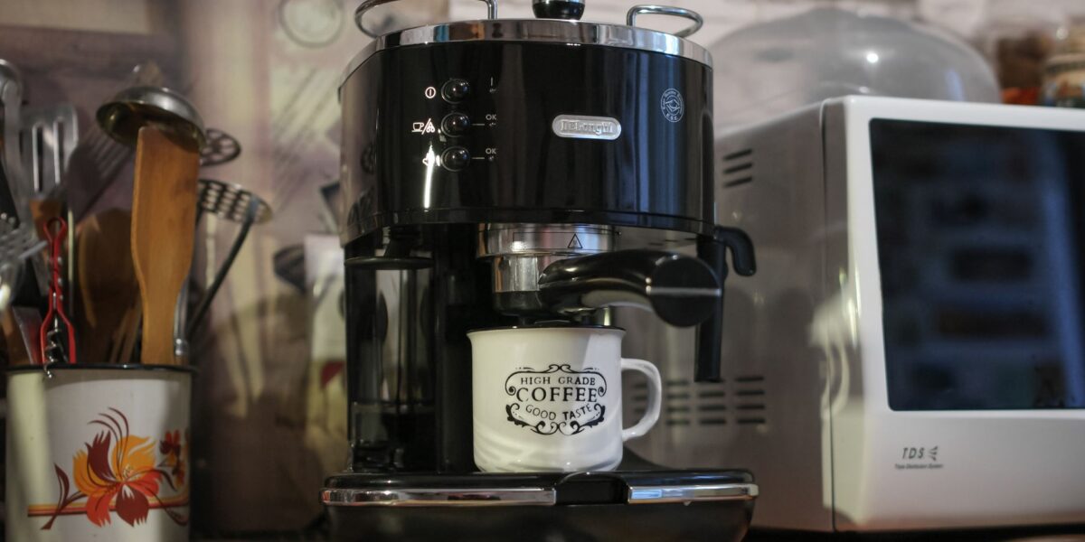 A Delonghi espresso machine brews coffee in a cozy kitchen setting. Perfect for caffeine lovers.