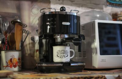 A Delonghi espresso machine brews coffee in a cozy kitchen setting. Perfect for caffeine lovers.