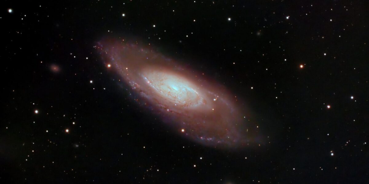 A captivating image of a spiral galaxy surrounded by stars in deep space, showcasing cosmic beauty.