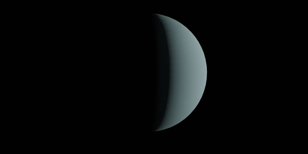 Half-lit planet resembling a crescent against a dark space backdrop.