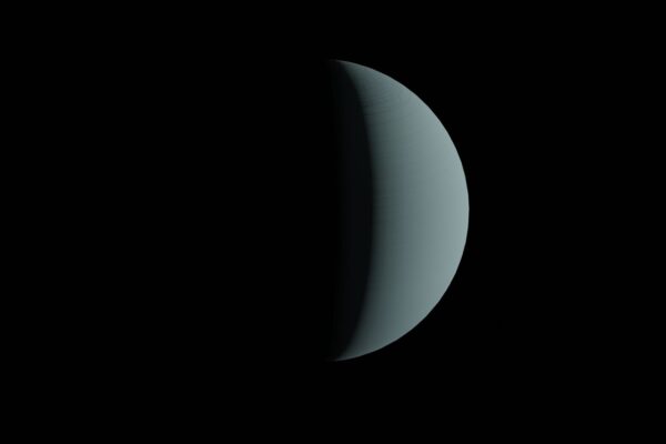 Half-lit planet resembling a crescent against a dark space backdrop.