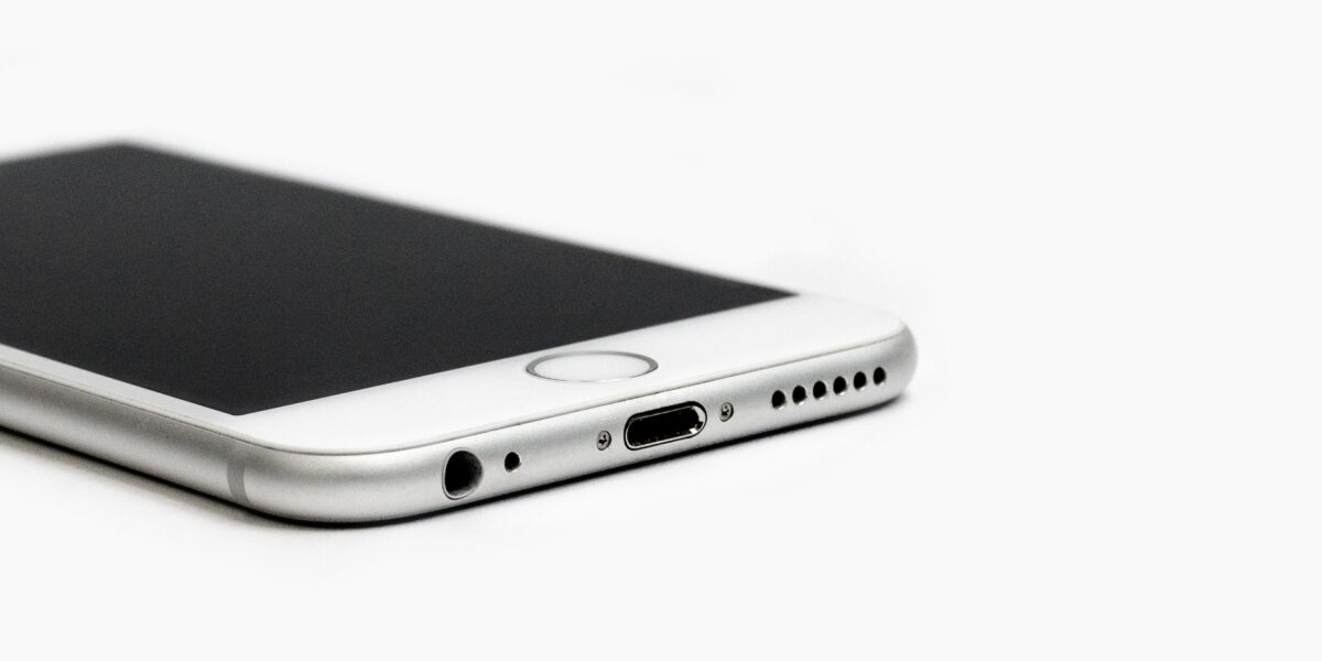 Minimalist image of a sleek smartphone with focus on the bottom edge and ports.