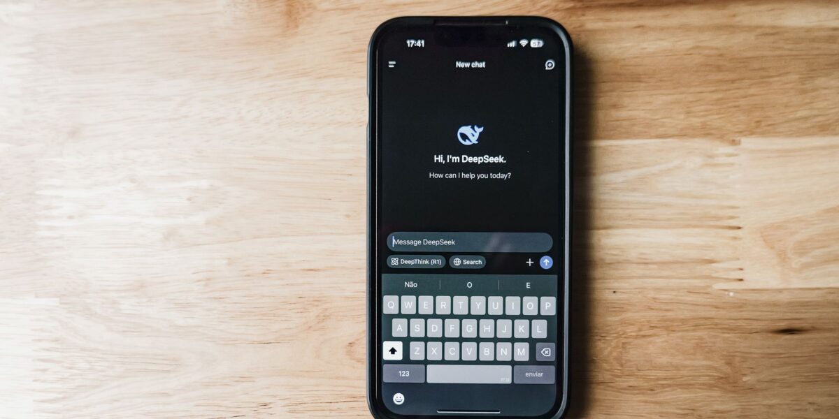 A smartphone on a wooden table showing an AI chatbot interface called DeepSeek.