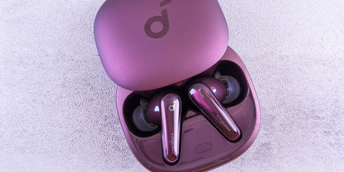 Modern purple earbuds resting in an open case, featuring glossy finish and sleek design.