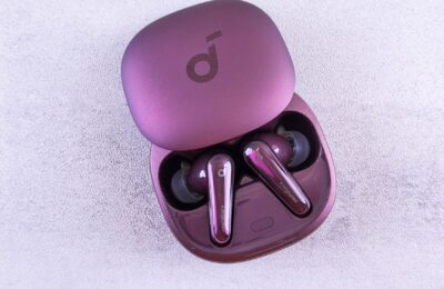 Modern purple earbuds resting in an open case, featuring glossy finish and sleek design.