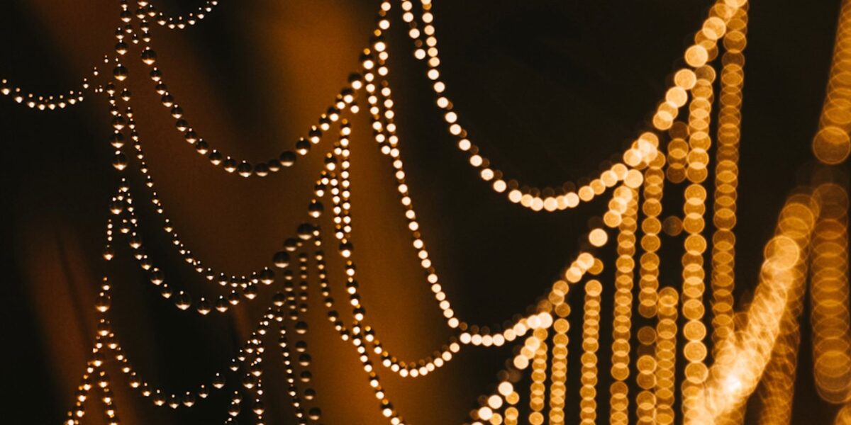 Abstract close-up of golden bokeh lights resembling strings. Perfect for festive and artistic themes.