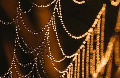 Abstract close-up of golden bokeh lights resembling strings. Perfect for festive and artistic themes.