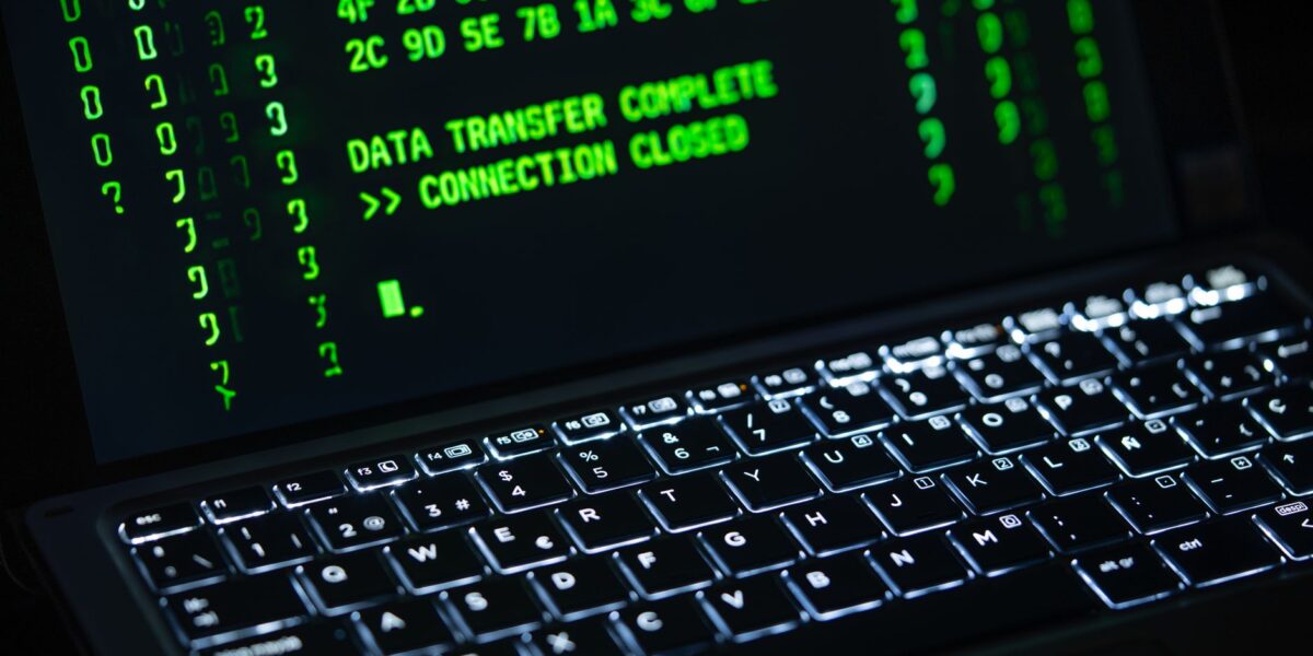 Close-up of a laptop screen displaying green code text. Perfect for cybersecurity themes.