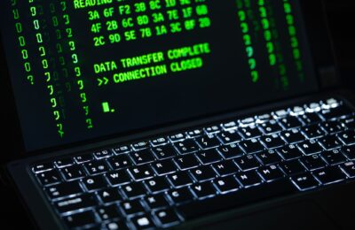 Close-up of a laptop screen displaying green code text. Perfect for cybersecurity themes.