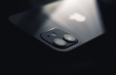 Close-up shot of a smartphone camera lens reflecting light, highlighting modern technology.