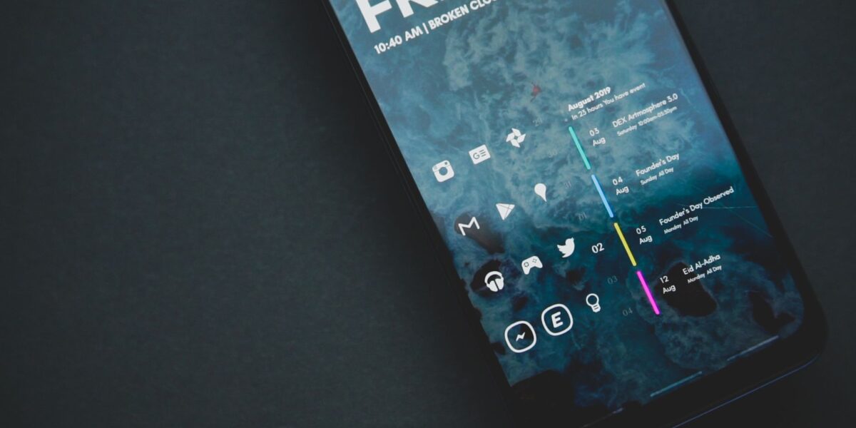 Close-up of a smartphone with a custom digital interface and various icons.