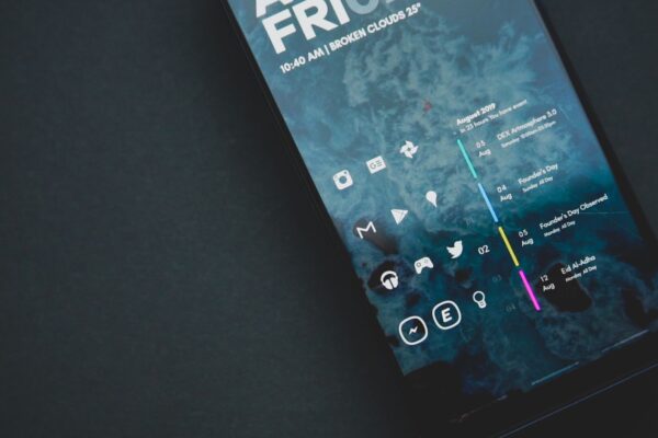 Close-up of a smartphone with a custom digital interface and various icons.
