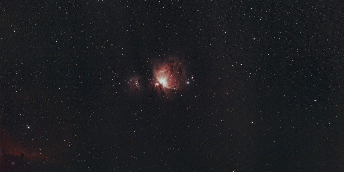A captivating image of the Orion Nebula under a clear starry sky, showcasing the wonders of the universe.