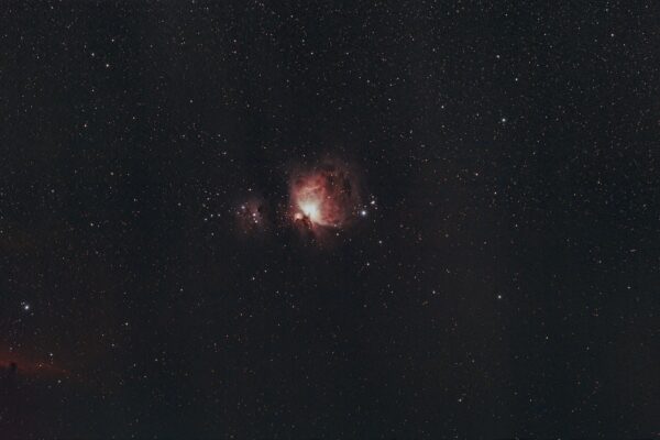 A captivating image of the Orion Nebula under a clear starry sky, showcasing the wonders of the universe.