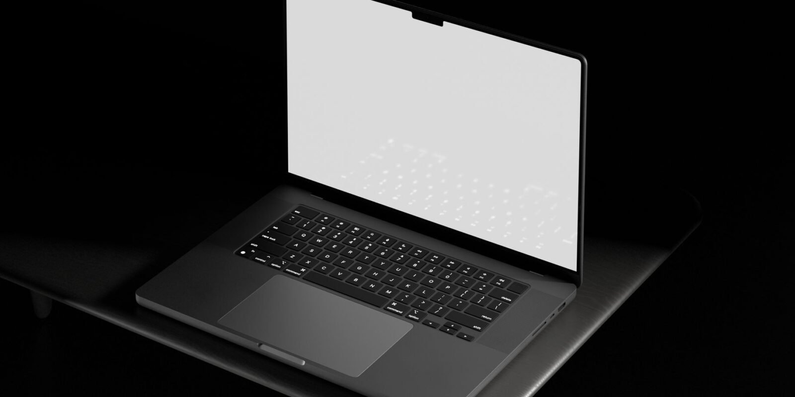 Open laptop with a blank white screen on a table in a dark setting, suitable for mockups and designs.