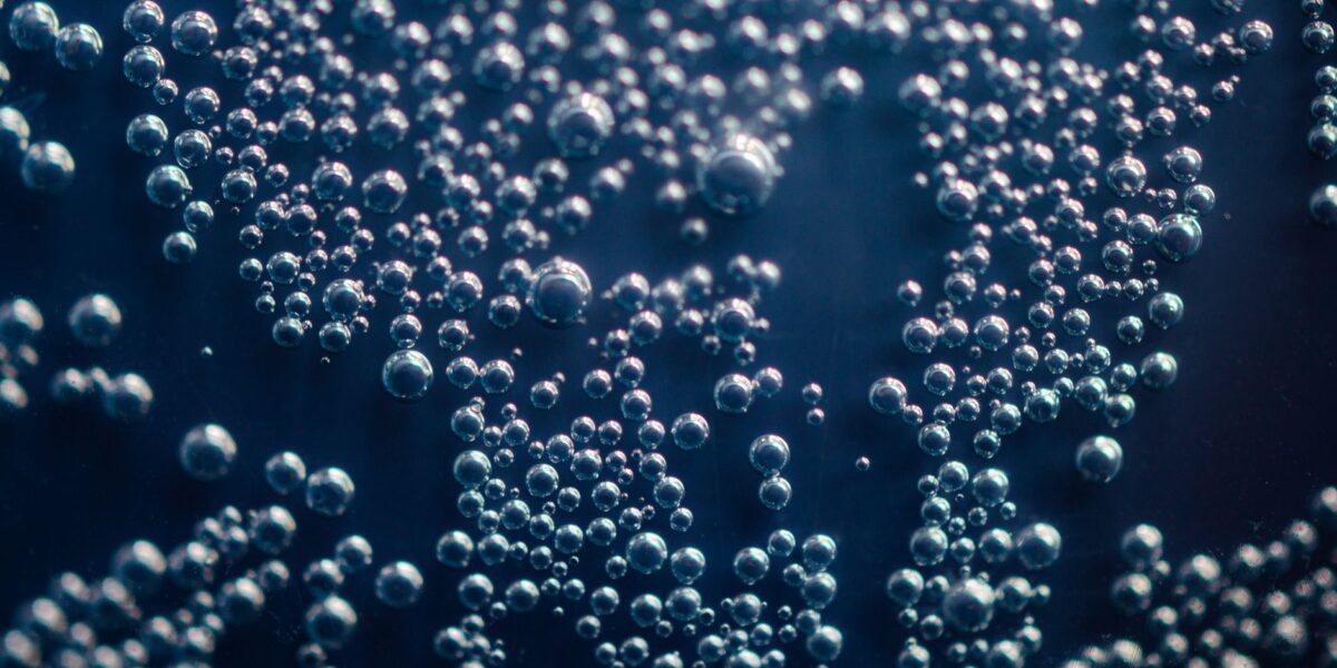 Detailed macro shot of shimmering bubbles suspended in a liquid medium.