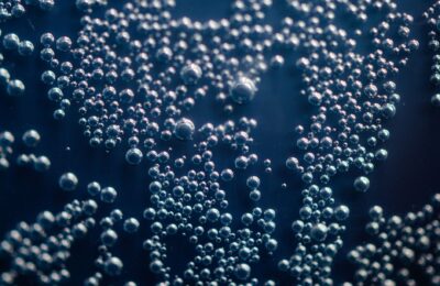 Detailed macro shot of shimmering bubbles suspended in a liquid medium.