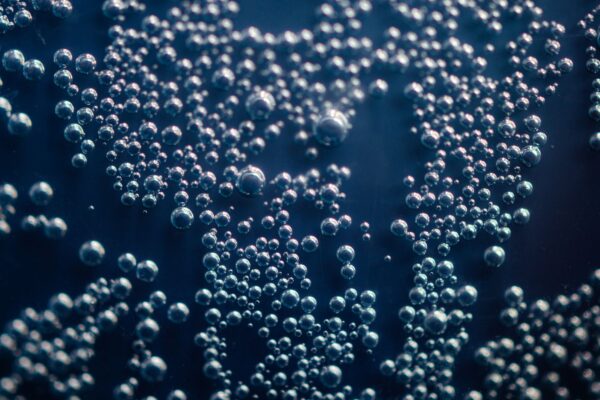 Detailed macro shot of shimmering bubbles suspended in a liquid medium.