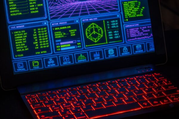 Futuristic digital interface displayed on laptop screen with neon red keyboard.