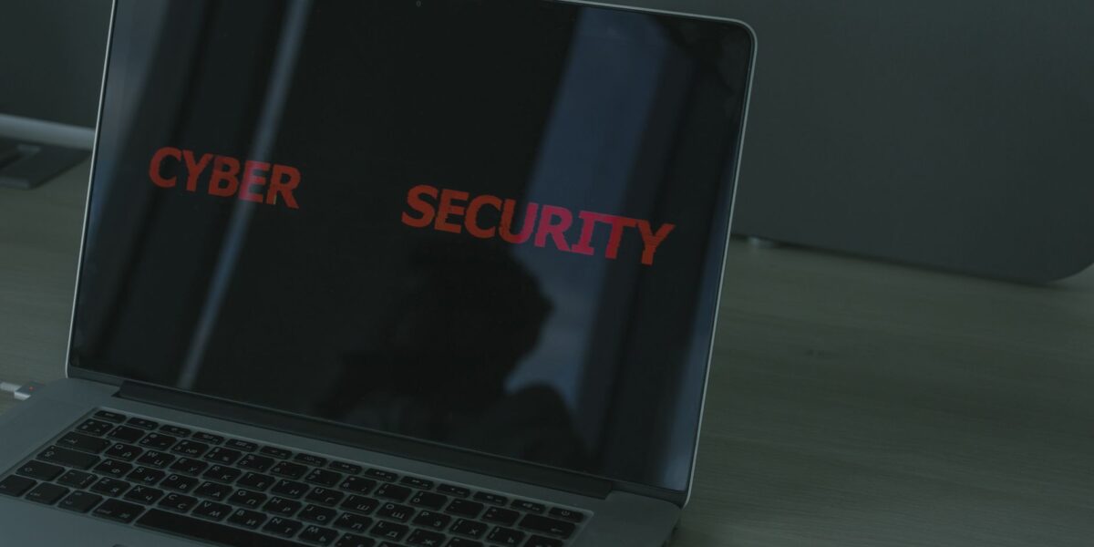 Close-up of a laptop displaying cybersecurity text, emphasizing digital security themes.