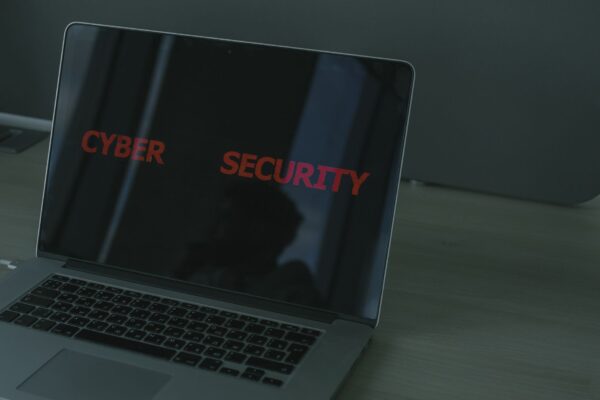 Close-up of a laptop displaying cybersecurity text, emphasizing digital security themes.