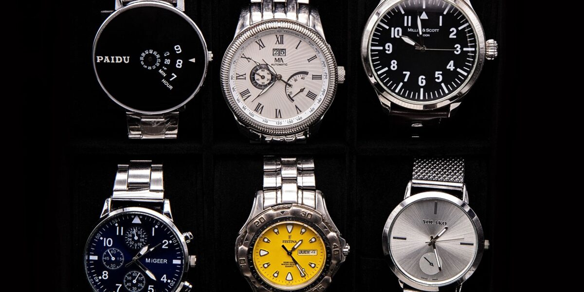 A variety of sophisticated wristwatches displayed against a dark background.