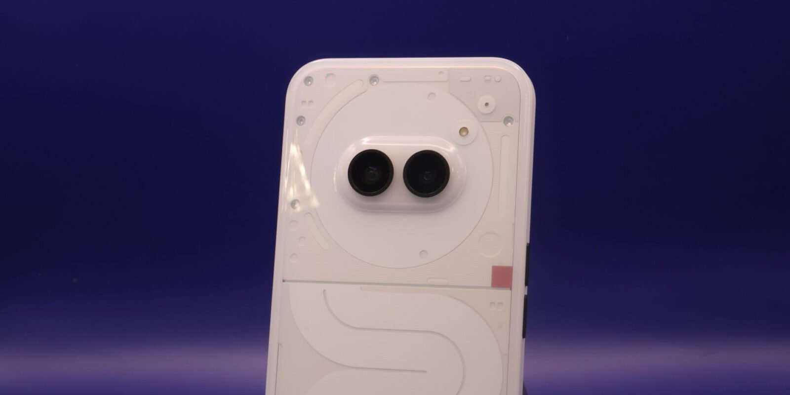 A sleek smartphone with dual cameras against a vibrant blue background.