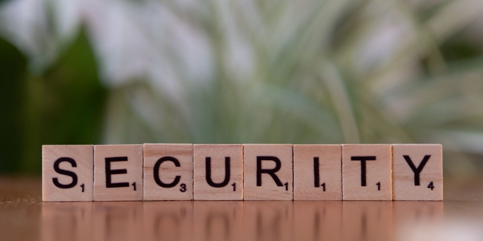 Close-up of wooden Scrabble tiles spelling SECURITY, symbolizing cybersecurity and protection.