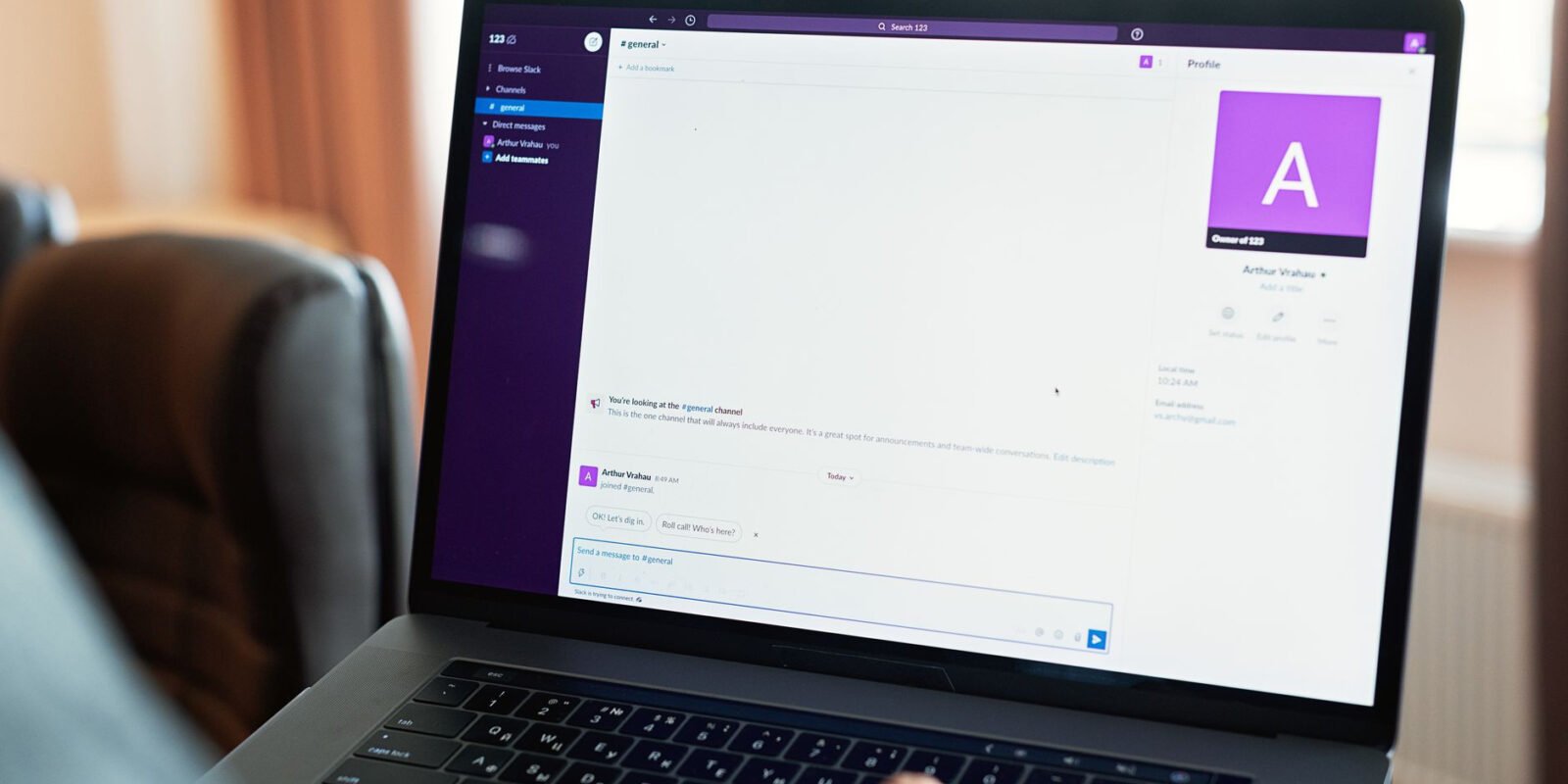 Person using a laptop with an online communication platform, showcasing modern work tech.